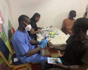 Lab Personnel taking a beneficiaries Sample at Mrs Opeyemi's Birthday held on the 18th of January 2025
