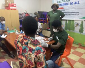 Lab Personnel taking a beneficiaries Sample at Mrs Opeyemi's Birthday held on the 18th of January 2025