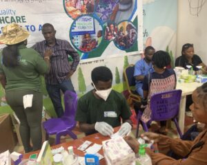 Lab Personnel taking a beneficiaries Sample at Mrs Opeyemi's Birthday held on the 18th of January 2025